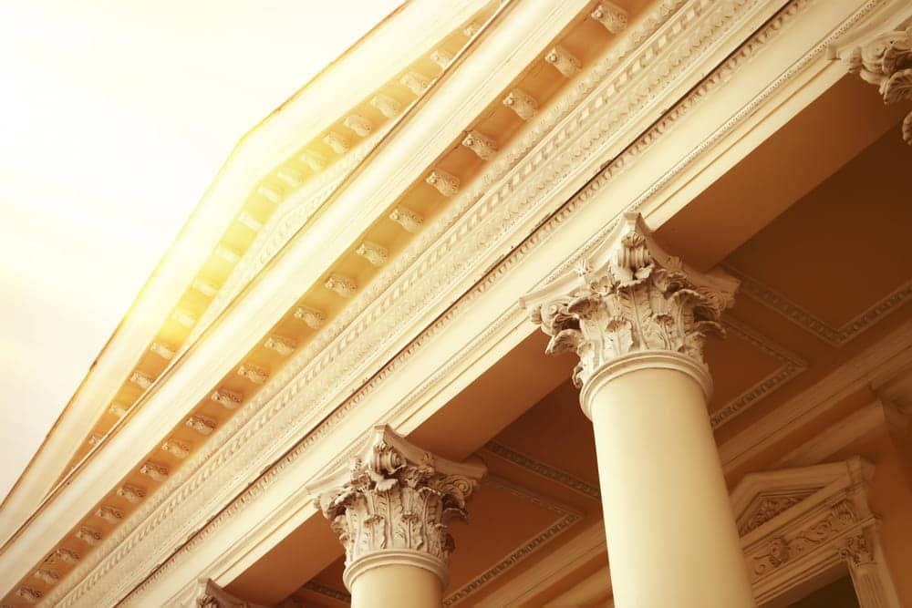 Image is of courthouse columns in sunlight, representing the justice system and legal paths for sexual assault survivors.