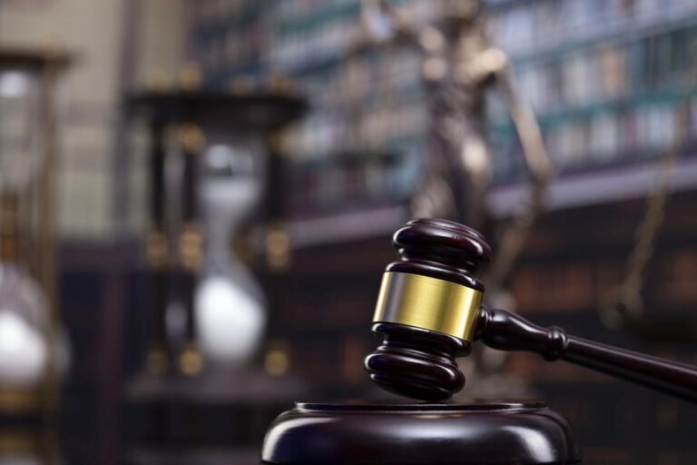 Image is of a judge’s gavel on a courtroom desk, symbolizing legal proceedings and justice options for sexual assault survivors.