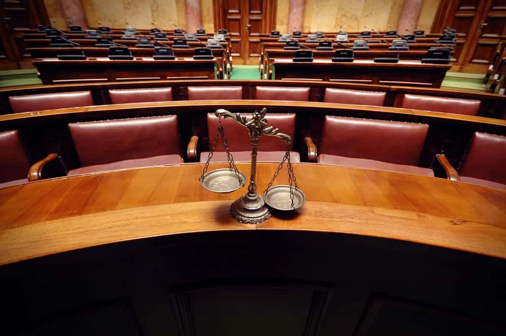 Image is of legal professionals discussing a case in a meeting, concept of class actions and case evaluation