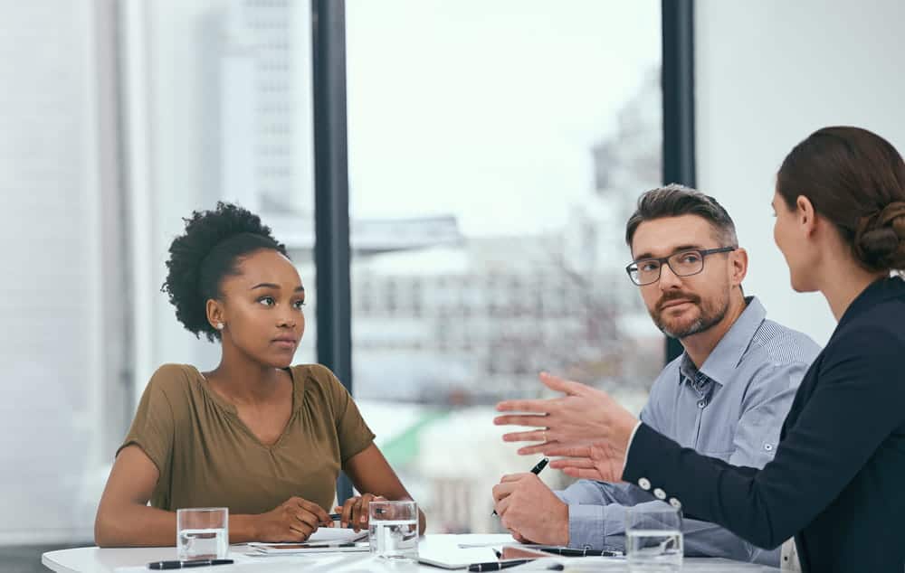 Image is of a courtroom with scales of justice in focus, concept of class actions and legal proceedings.