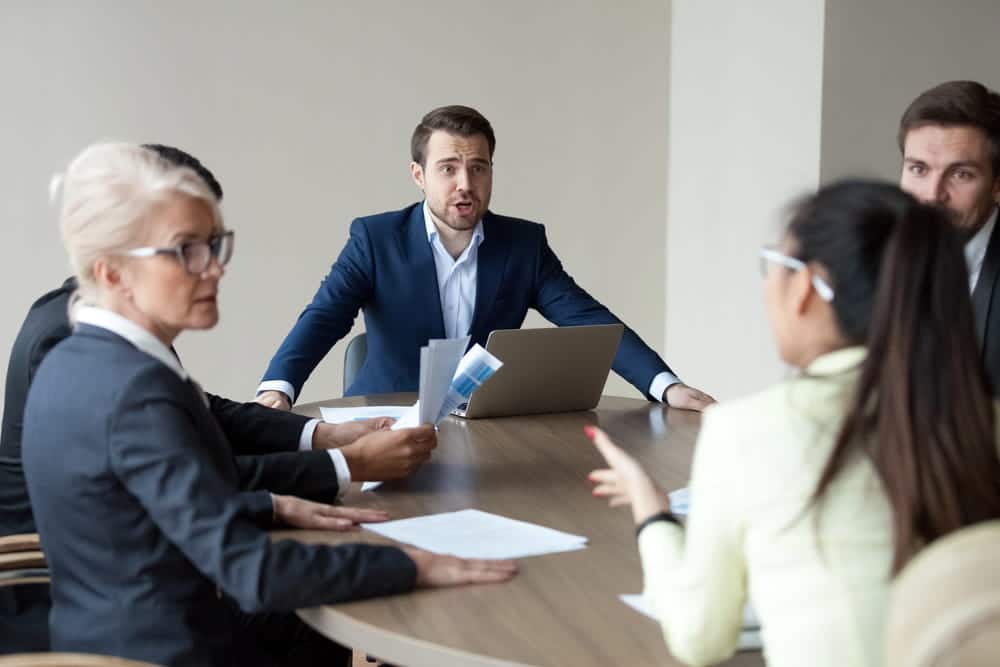 Image is of legal professionals reviewing documents during a formal workplace negotiation, illustrating collective bargaining in action.