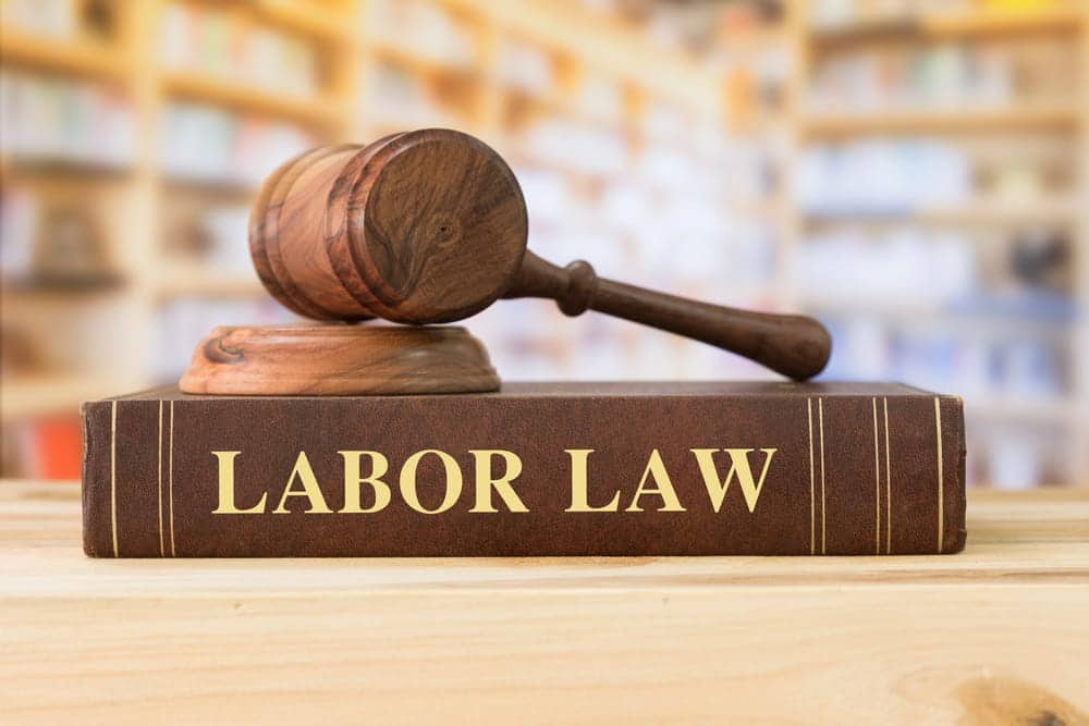 Image is of a gavel resting on a book labeled labor law, representing legal protections and rights for union workers in Nashville