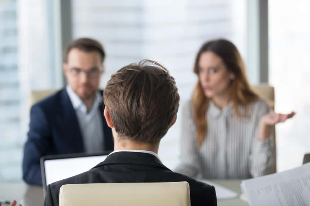 Image is of employees participating in a workplace meeting, concept of labor contract negotiations and employer disputes in Ohio.