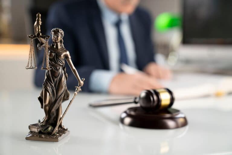 Image is of a Lady Justice statue and gavel inside a law office, concept of mass torts in Cincinnati.