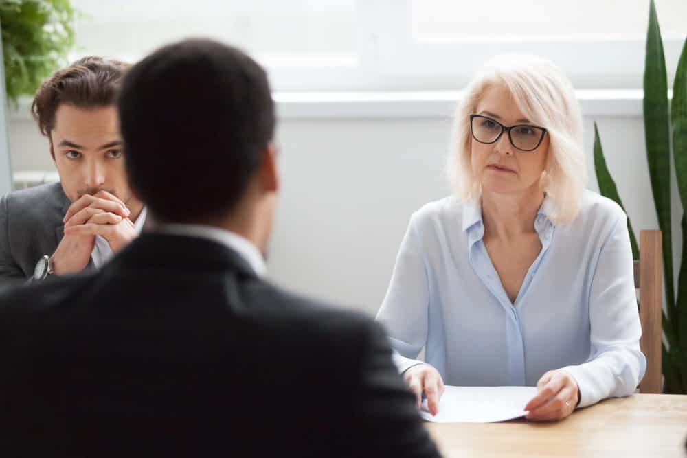 Image is of a lawyer meeting with clients during a legal consultation, concept of mass torts in Cincinnati.