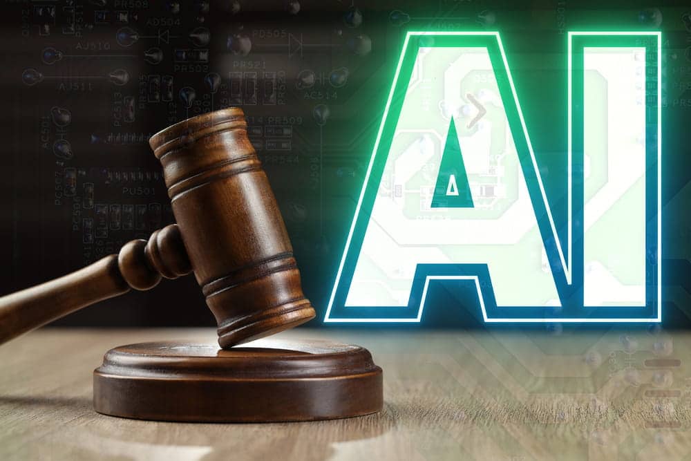 Image is of a judge's gavel positioned beside illuminated artificial intelligence lettering, concept of AI harassment and the legal accountability issues that may result in civil liability claims.