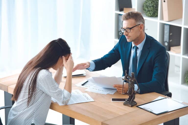 Image is of an attorney meeting with a client to discuss legal options, concept of a sexual assault claim in Nashville.