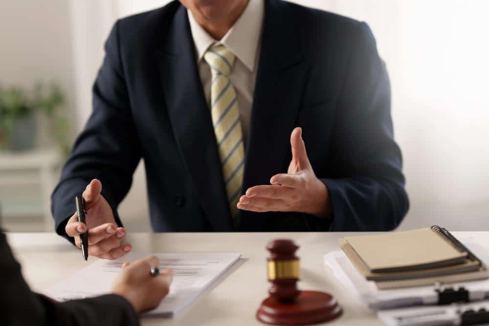 Image is of an attorney discussing a legal matter with a client, concept of sexual assault in D.C.