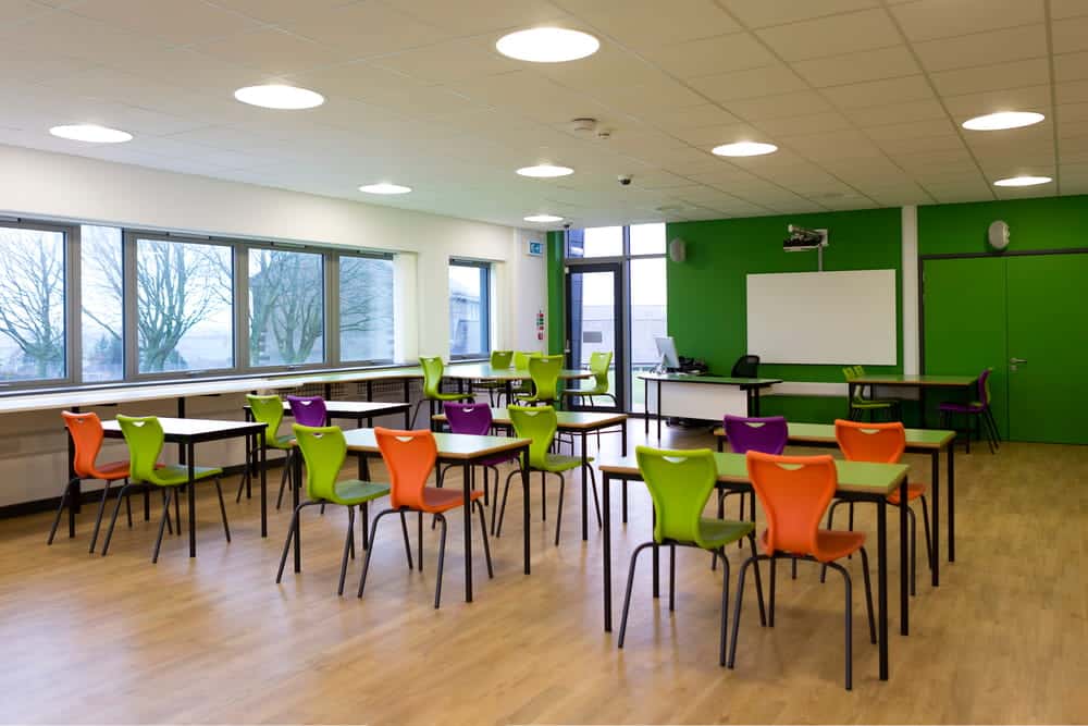 Image is of an empty classroom representing institutional responsibility, concept of sexual assault in D.C.