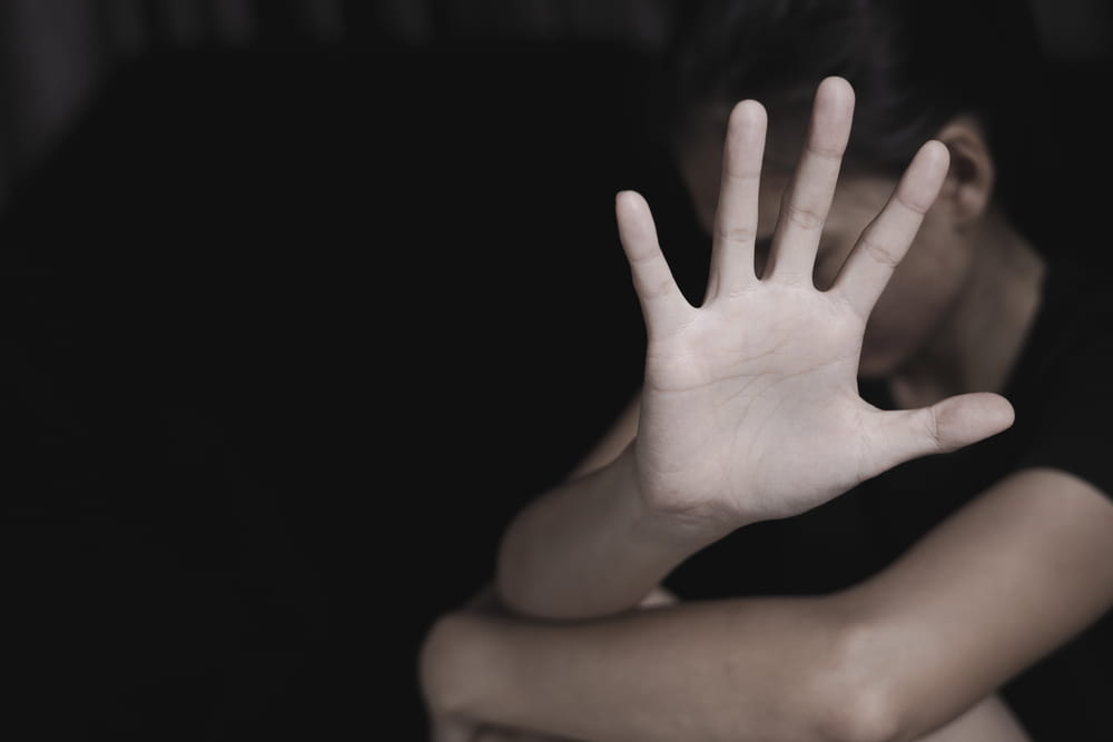 Image is of a person raising a hand to seek protection, concept of sexual assault in D.C.