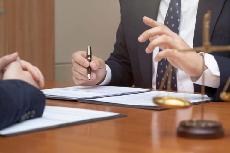 Image is of an attorney discussing legal options with a client, concept of a mass tort claim in Washington, D.C.