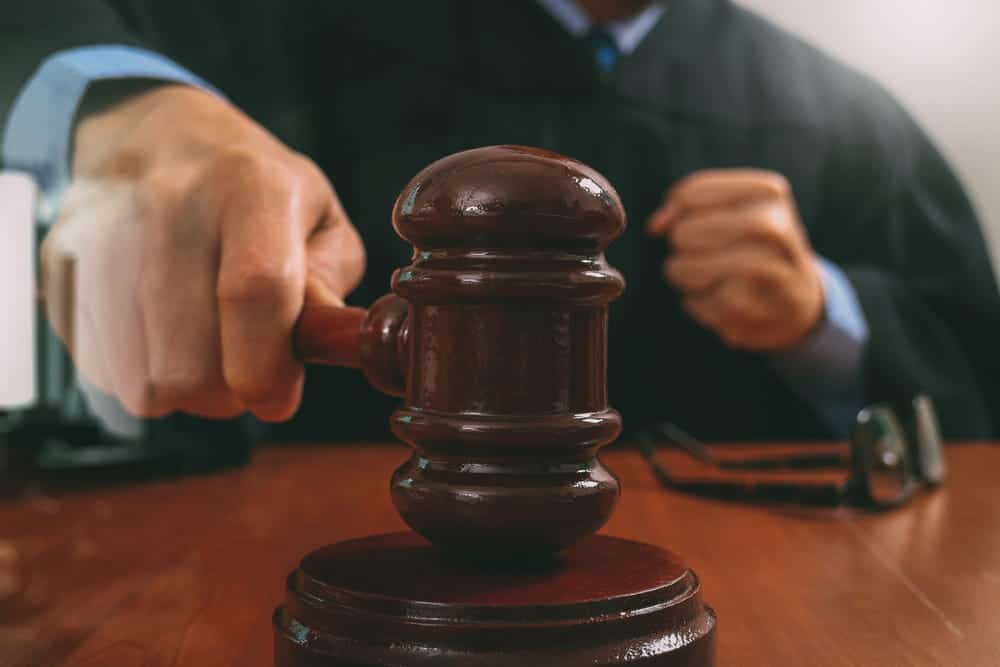 Image is of a judge using a gavel during court proceedings, concept of a mass tort claim in Washington, D.C.