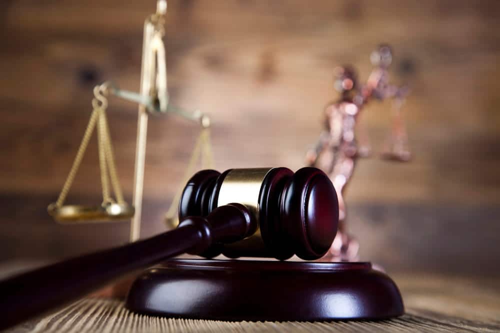 Image is of a judge’s gavel and scales of justice, concept of a defective breast mesh lawsuit in Ohio.