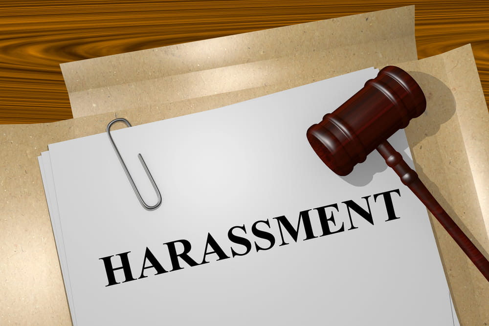 Image is of a gavel beside a document labeled harassment, concept of sexual assault in Kentucky and institutional liability claims.