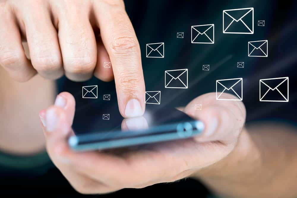 Image is of a person using a smartphone with message icons, representing digital communications that may provide evidence in a sexual assault lawsuit.
