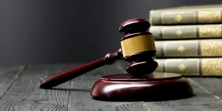 Image is of a judge’s gavel beside law books, concept of civil liability for sexual assault in Cincinnati.